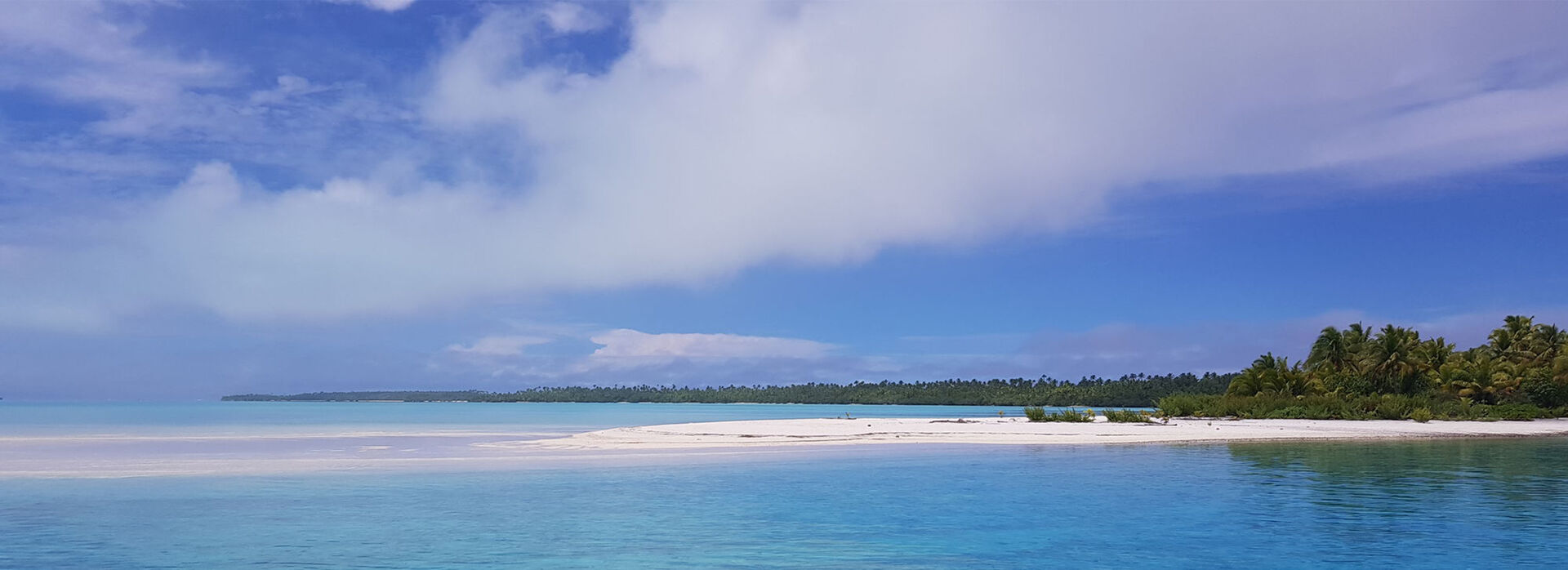 Cook Island tropical white sand beach with sparkling blue water